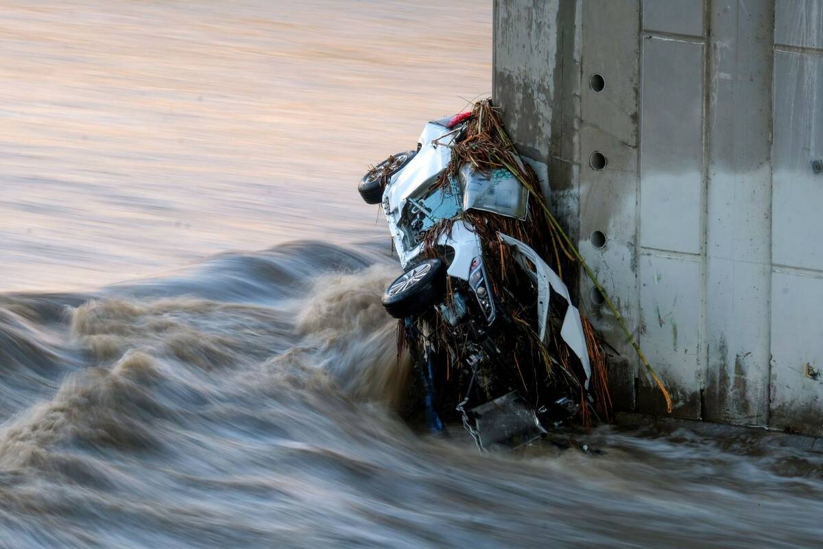 A vehicle is seen in the Los Angeles River at the Washington Bridge near downtown Los Angeles o ...