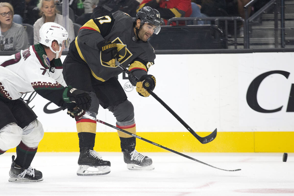 Golden Knights left wing Max Pacioretty (67) makes a shot on goal as Coyotes defenseman Victor ...