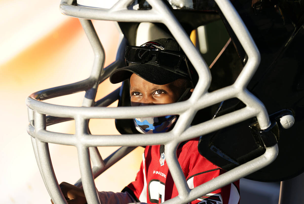 Isaiah Sheppard, 7, sits inside an oversized football helmet at the NFL Experience for Super Bo ...