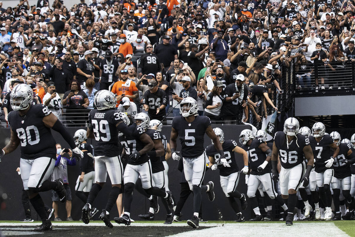 Raiders players take the field to face the Chicago Bears during an NFL football game at Allegia ...
