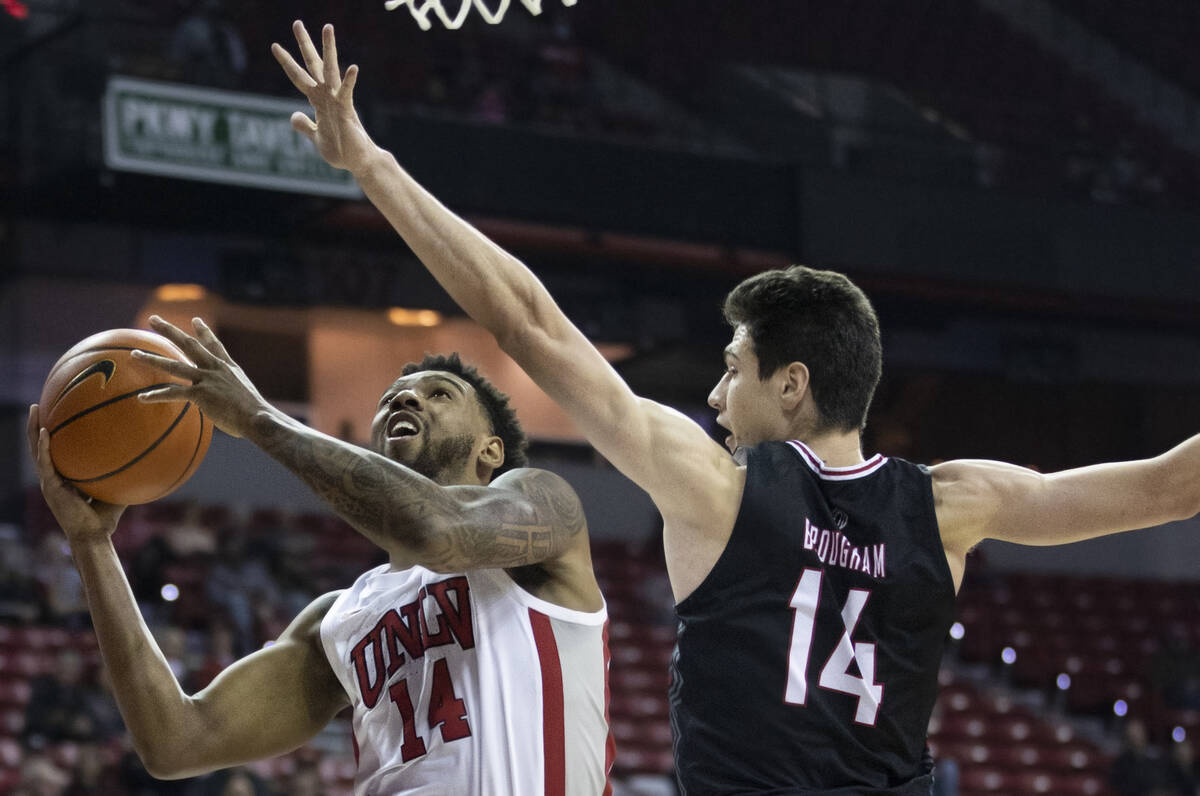 UNLV Rebels forward Royce Hamm Jr. (14) drives past Omaha Mavericks center Dylan Brougham (14) ...