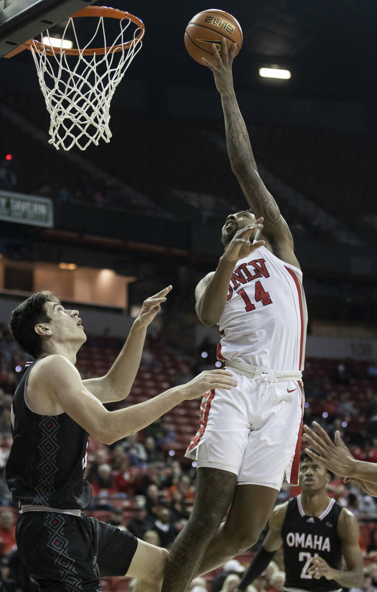 UNLV Rebels forward Royce Hamm Jr. (14) shoots over Omaha Mavericks center Dylan Brougham (14) ...