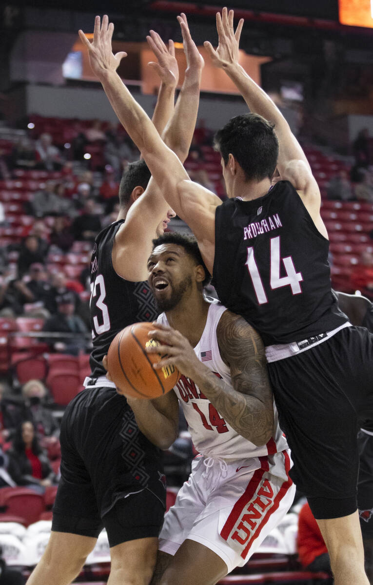 UNLV Rebels forward Royce Hamm Jr. (14) gets fouled by Omaha Mavericks center Dylan Brougham (1 ...