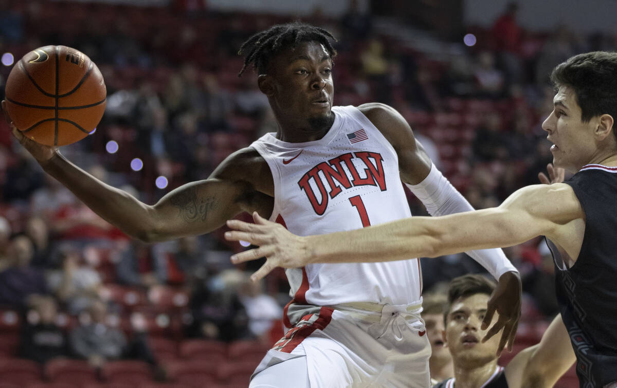 UNLV Rebels guard Michael Nuga (1) makes a baseline pass around Omaha Mavericks center Dylan Br ...