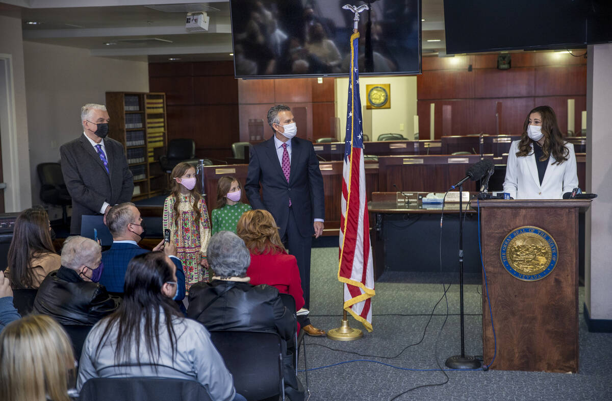 Incoming Lt. Gov. Lisa Cano Burkhead, from right, speaks while joined by her husband Jeffery wi ...