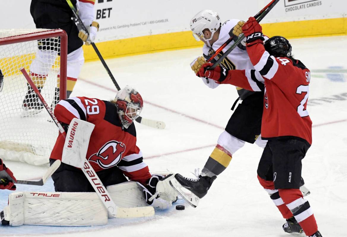 New Jersey Devils goaltender Mackenzie Blackwood (29) stops the puck as Devils defenseman Ty Sm ...