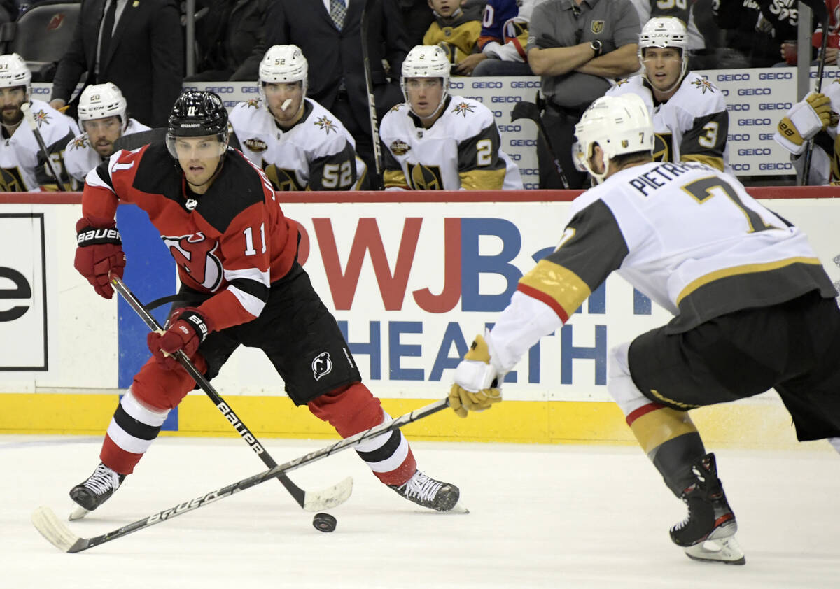 New Jersey Devils left wing Andreas Johnsson (11) looks to pass the puck as Vegas Golden Knight ...