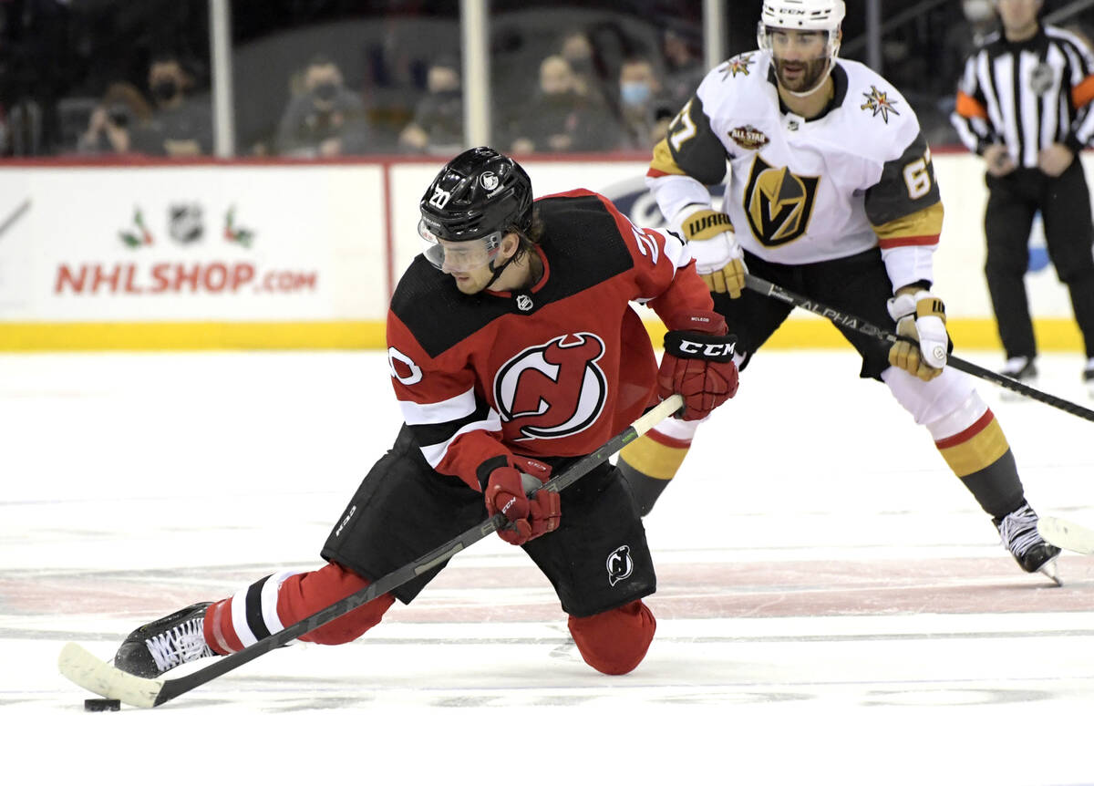 New Jersey Devils center Michael McLeod (20) passes the puck as Vegas Golden Knights left wing ...