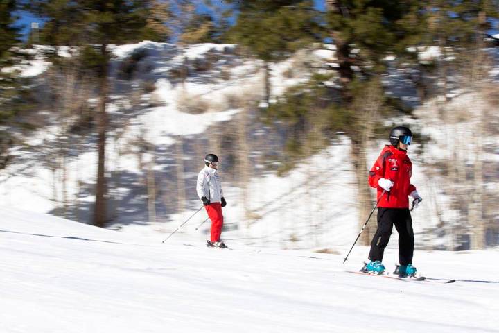 Ryan Han, center, and his daughter Chloe Han, 13, glide down Rabbit Peak during opening day at ...