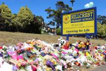 Flowers and tributes are seen outside Hillcrest Primary School in Devonport, in the island stat ...