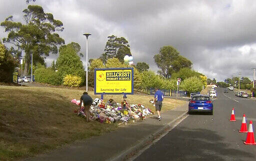 In this image made from video, people lay flowers at a makeshift memorial outside the Hillcrest ...