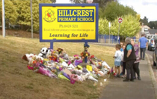 In this image made from video, people lay flowers at a makeshift memorial outside the Hillcrest ...