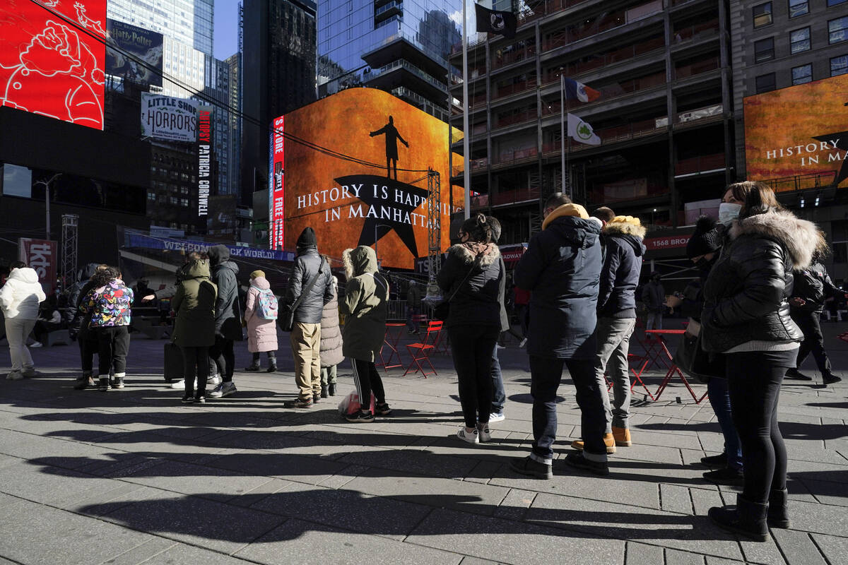 People wait in a long line to get tested for COVID-19 in Times Square, New York, Monday, Dec. 2 ...