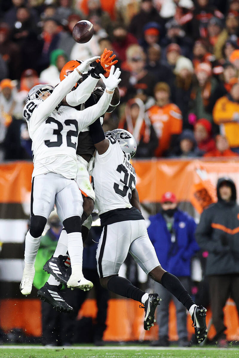 Raiders defensive back Dallin Leavitt (32) and cornerback Brandon Facyson (35) defend a pass in ...