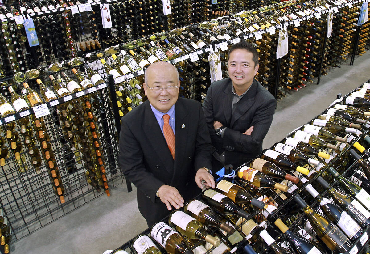 Hae Un Lee, CEO of Lee's Liquor,from left, poses with his son Kenny Lee, President, in their st ...