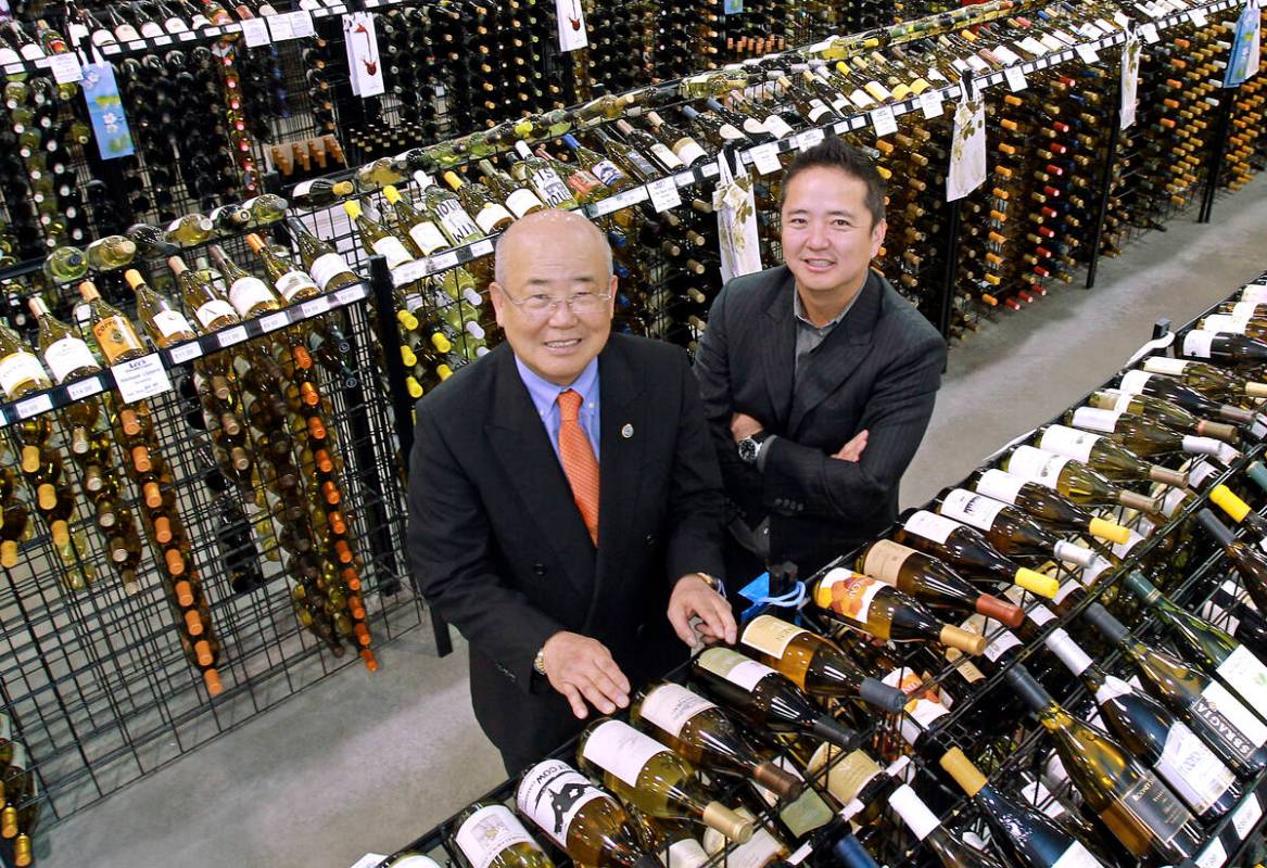 Hae Un Lee, CEO of Lee's Liquor,from left, poses with his son Kenny Lee, President, in their st ...