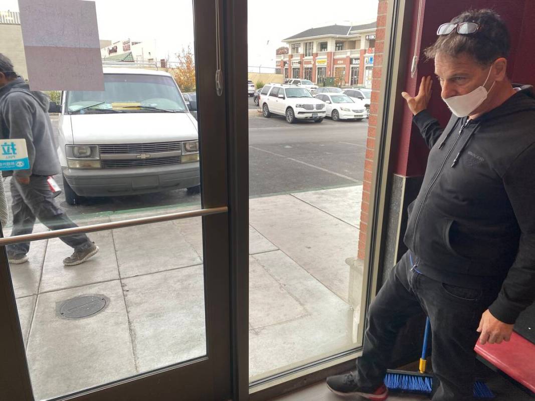 Joe Muscaglione, co-owner of ShangHai Taste, points to bullet holes left in the restaurant foll ...