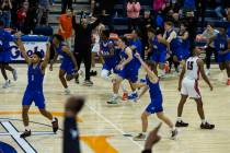 Bishop Gorman players celebrate their win in double overtime against Liberty High during Platin ...