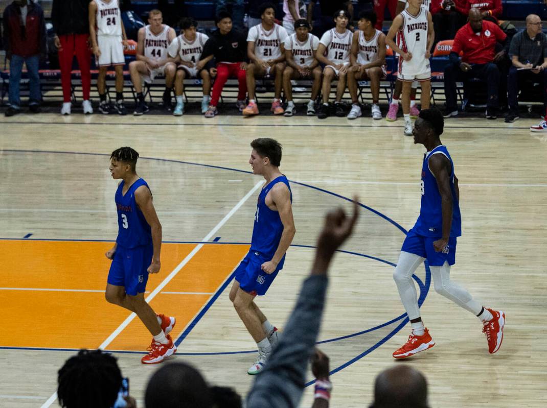 Bishop Gorman's John Mobley jr. (left) celebrates with his teammates after scoring the winning ...