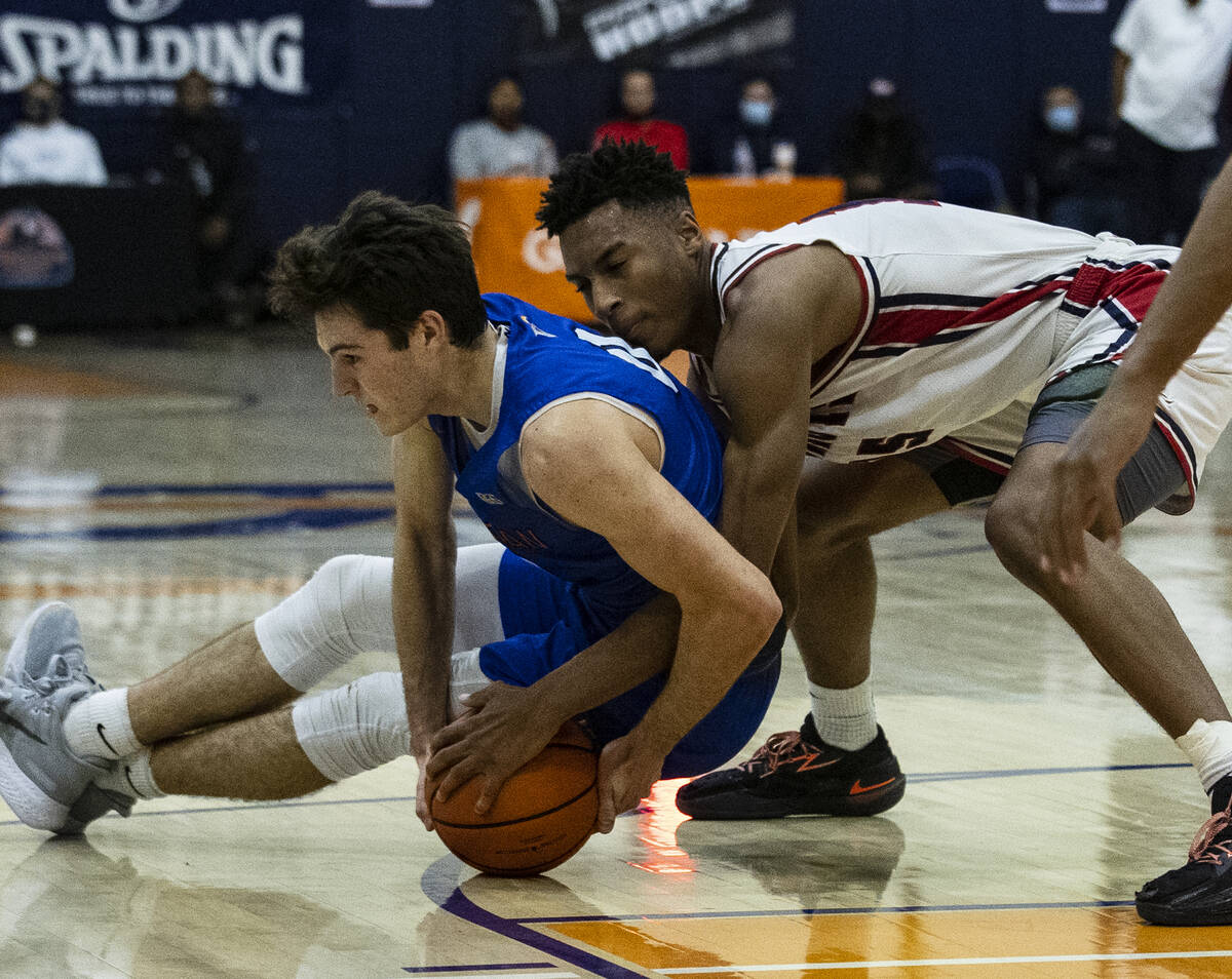 Bishop GormanÕs Ryan Abelman (0) and Liberty High Aaron Price Jr. (15) fight for the loose ...