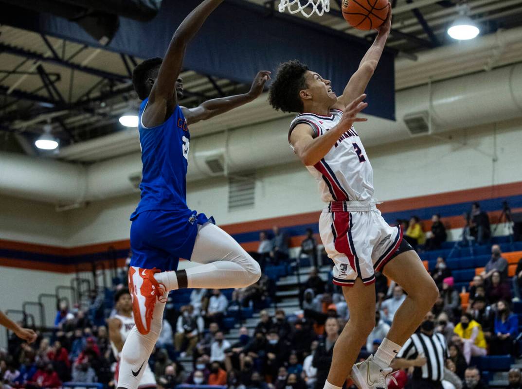 Liberty HighÕs Angelo Kambala (2) goes for the hoop as Bishop GormanÕs Chris Nwuli (2 ...