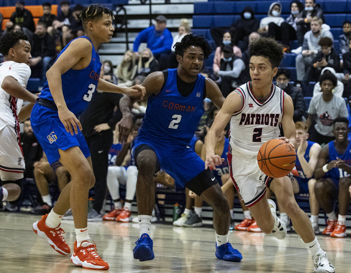 Liberty HighÕs Angelo Kambala (2) drives past Bishop GormanÕs John Mobley jr. (3) and ...