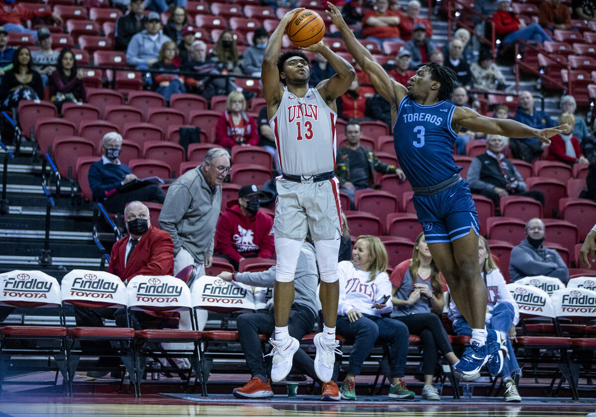 UNLV Rebels guard Bryce Hamilton (13) sets up for a three-point basket over San Diego Toreros g ...