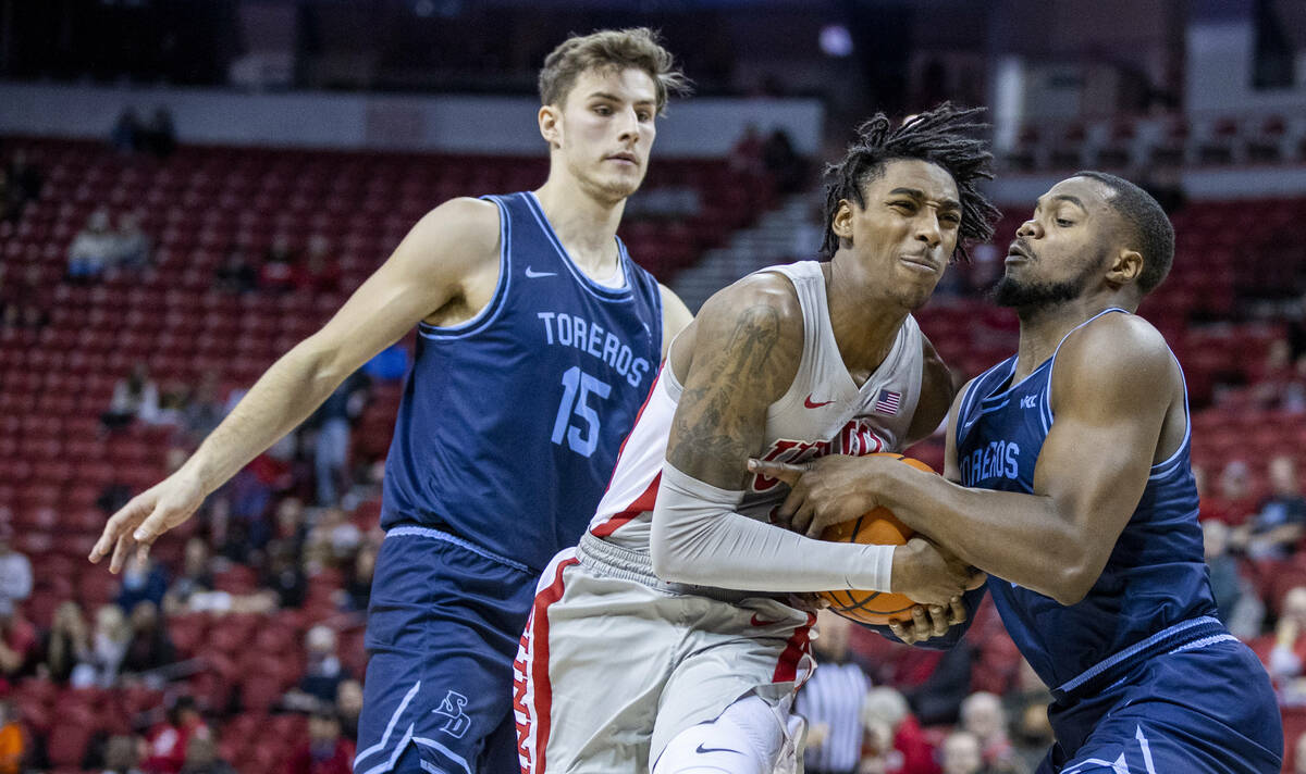 UNLV Rebels forward Donovan Williams (3) fights for the ball with San Diego Toreros forward Jos ...
