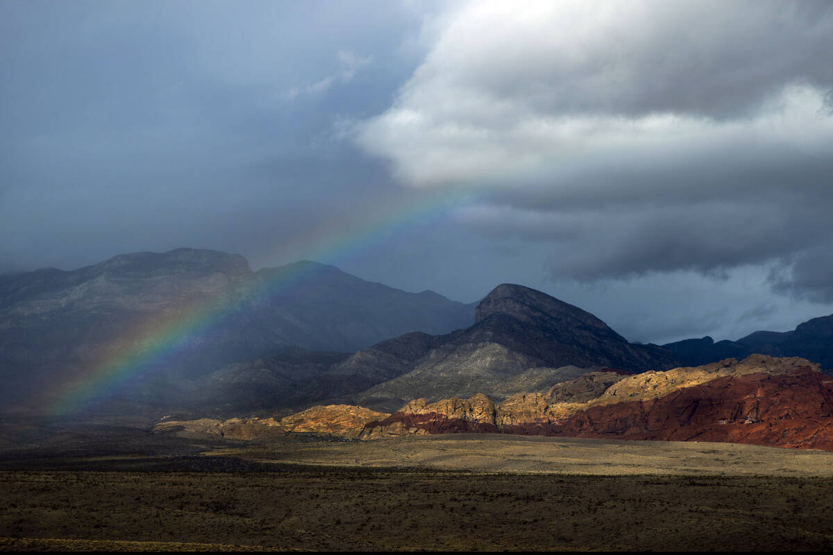 A rainbow appears above the valley floor at the Red Rock Canyon National Conservation Area as r ...