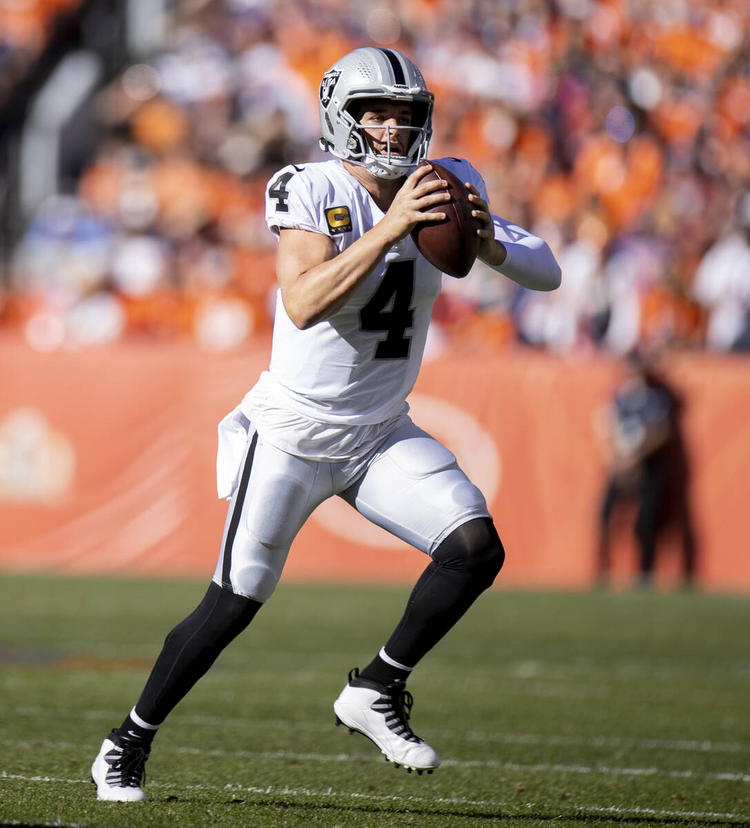 Raiders quarterback Derek Carr (4) looks for a receiver but will run for a few yards versus the ...