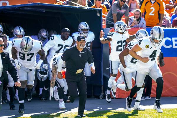RaidersÕ interim head coach Rich Bisaccia runs onto the field with his players to face the ...