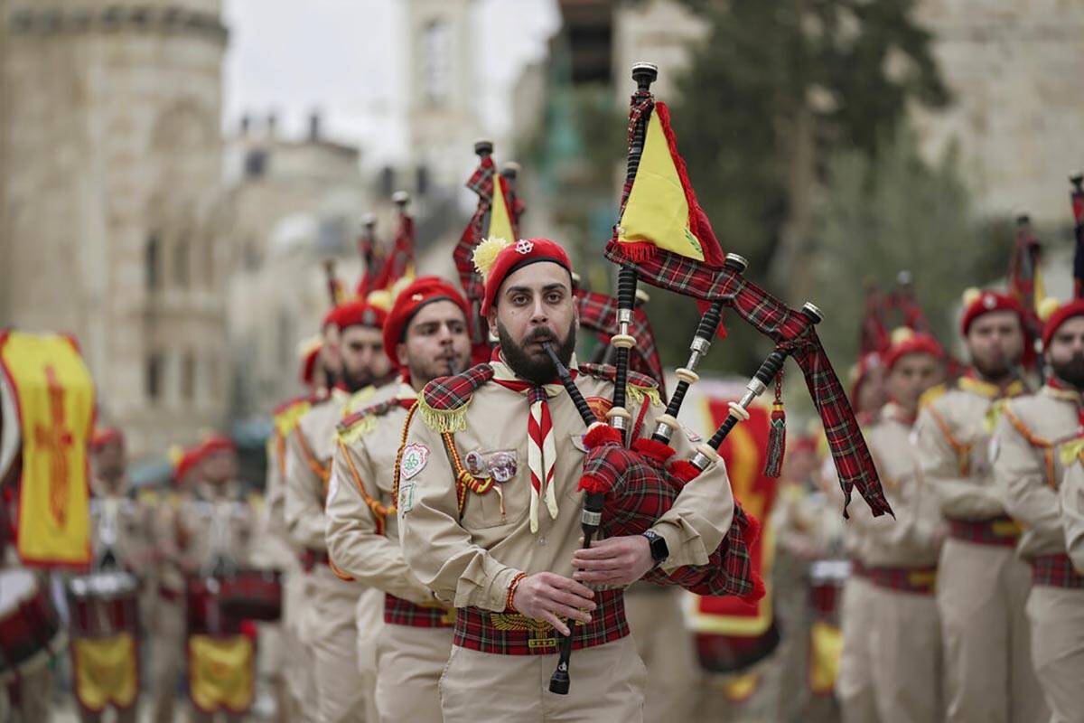 Palestinian scout band members parade through Manger Square at the Church of the Nativity, trad ...