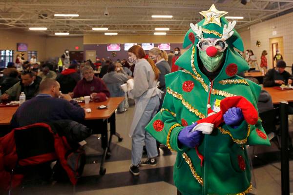 Volunteer Bette Kennedy of Las Vegas poses for a photo with her Christmas stocking filled with ...