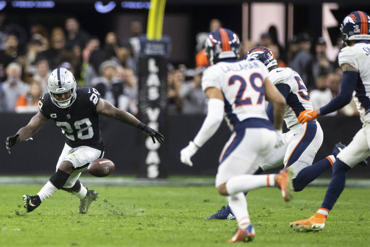 Raiders running back Josh Jacobs (28) fumbles the ball with Denver Broncos cornerback Bryce Cal ...