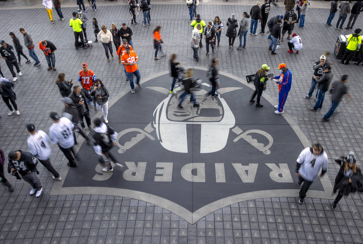 Raiders and Denver Broncos fans stream in from the north side before the first half of an NFL g ...