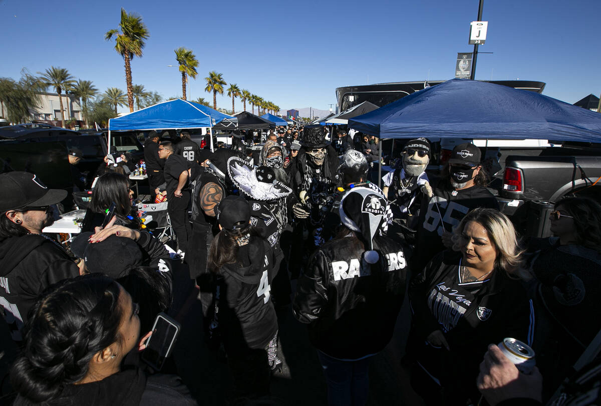 Raiders fans tailgate before an NFL football game at Allegiant Stadium in Las Vegas on Sunday, ...