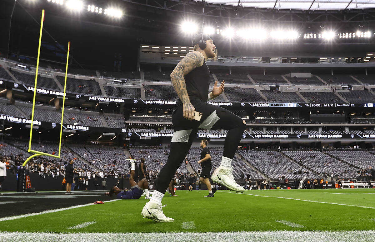 Raiders defensive end Maxx Crosby warms up before an NFL football game against the Denver Bronc ...