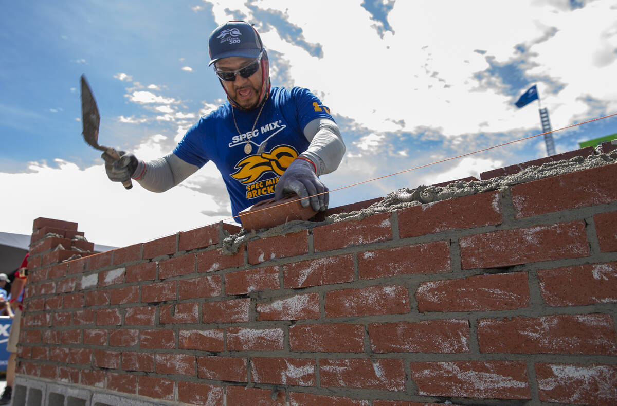 Competitor Jacob Ramirez of Houston, Texas, works his bricks and mortar in the Spec Mix Brickla ...