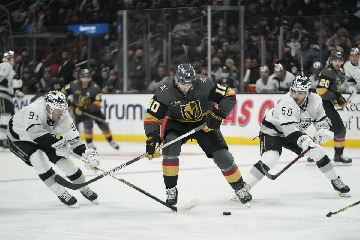 Los Angeles Kings right wing Carl Grundstrom (91) and defenseman Sean Durzi (50) defend against ...