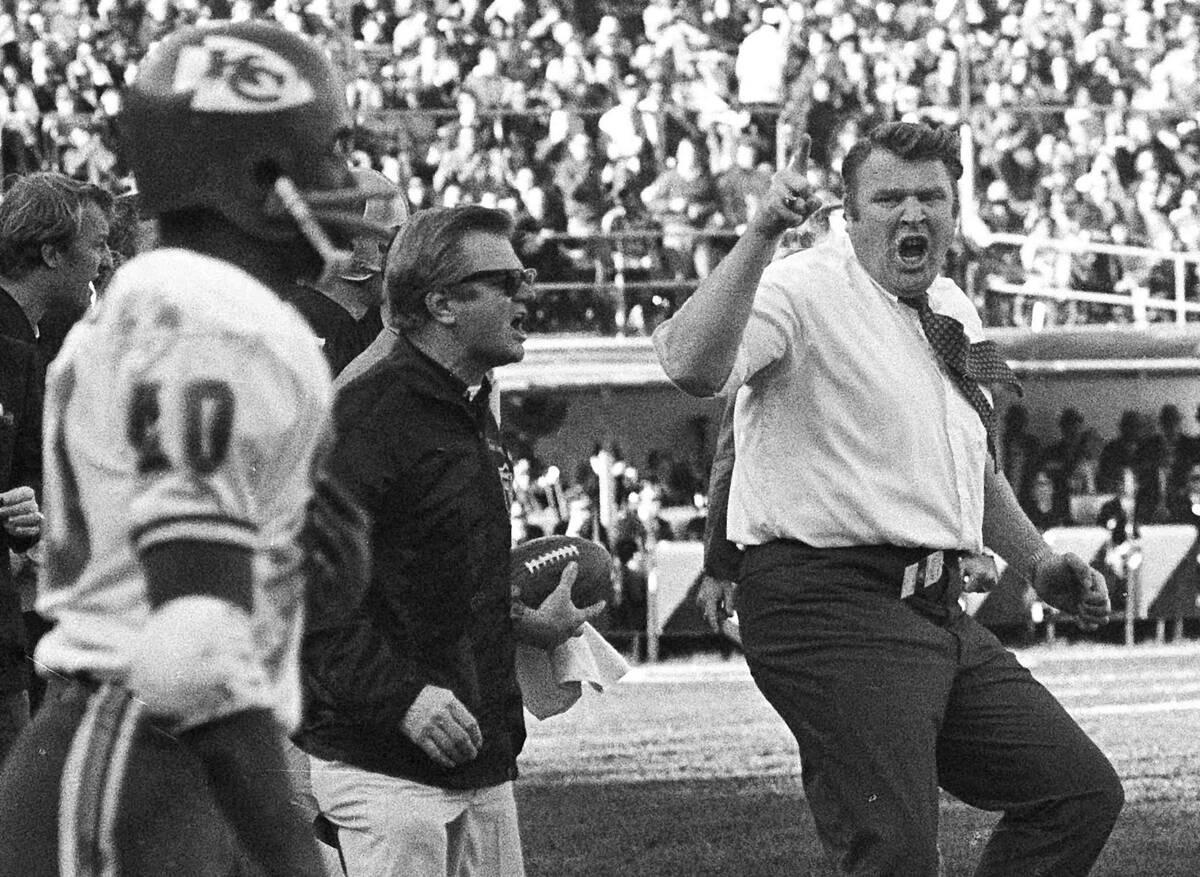 Oakland Raiders coach John Madden, right, does a sort of jig as he waves his finger and shouts ...