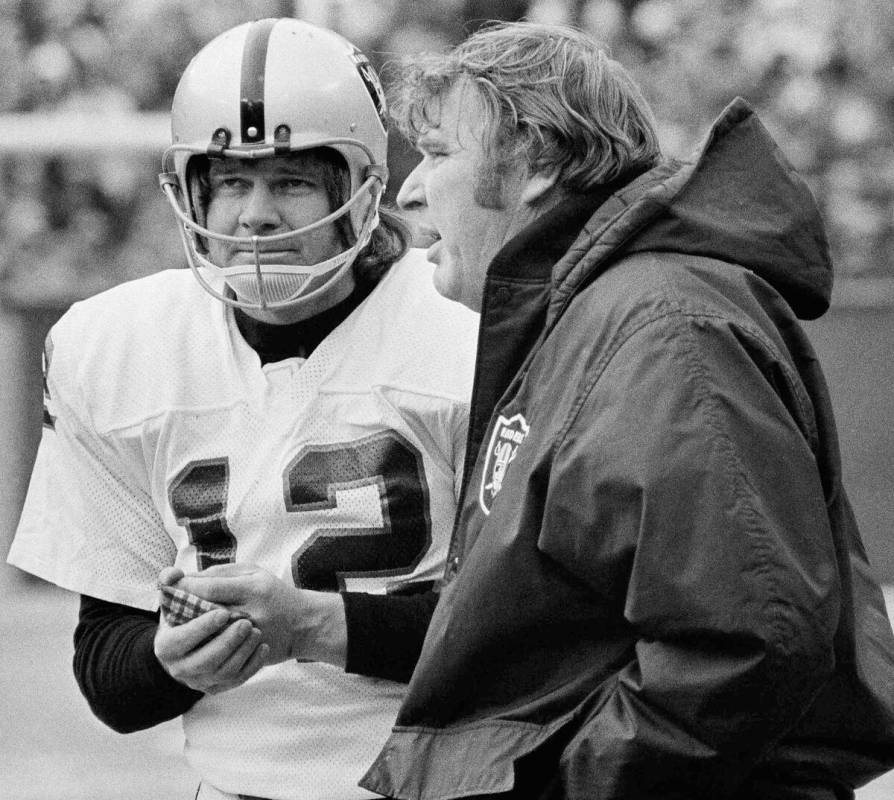 In this Jan. 4, 1976, file photo, Oakland Raiders quarterback Ken Stabler rubs his hands to war ...