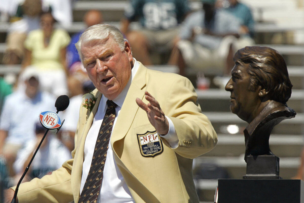 Former Oakland Raiders coach John Madden gestures toward his bust during his enshrinement into ...