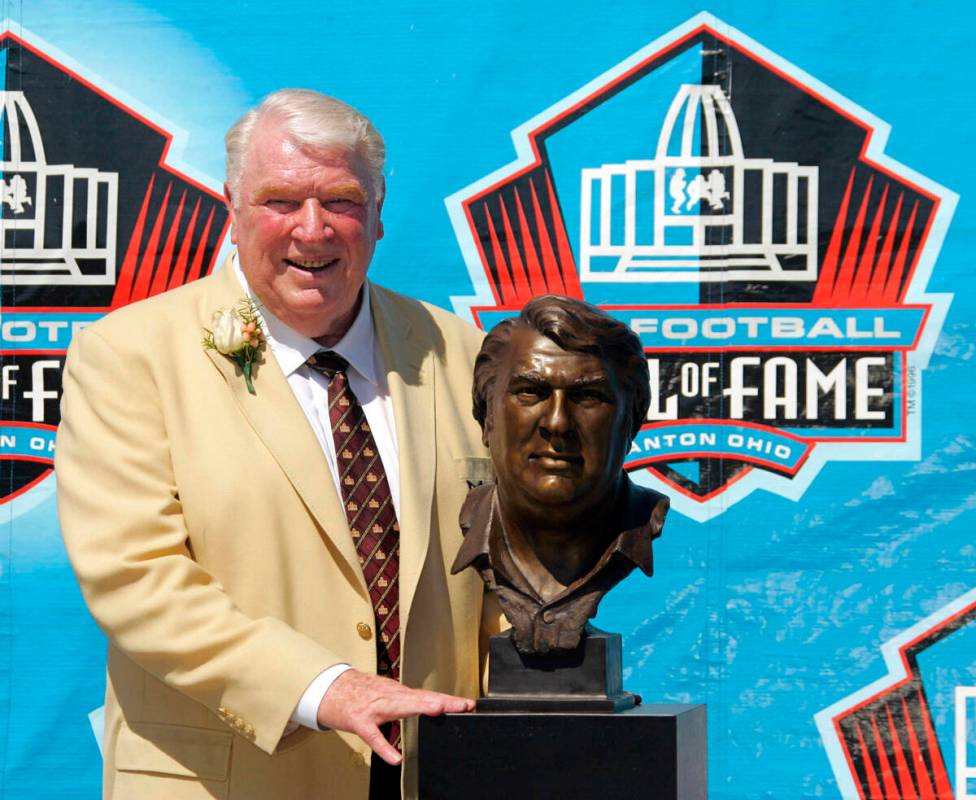 Broadcaster and former Oakland Raiders coach John Madden poses with his bust after enshrinement ...