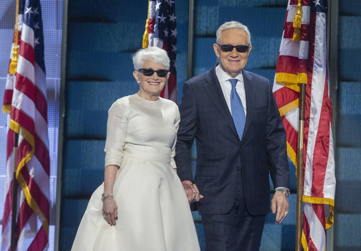 Senate Minority Leader Harry Reid and wife Landra walk onto the podium during the third day of ...