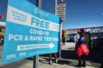 People line up for a free COVID-19 rapid test at a gas station in the Reseda section of Los Ang ...