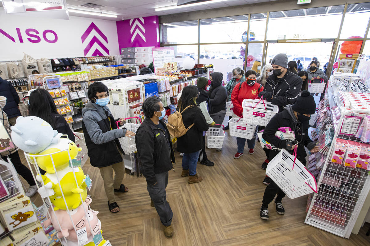 Customers shop during the grand opening of Daiso, a popular Japanese discount store, on Wednesd ...