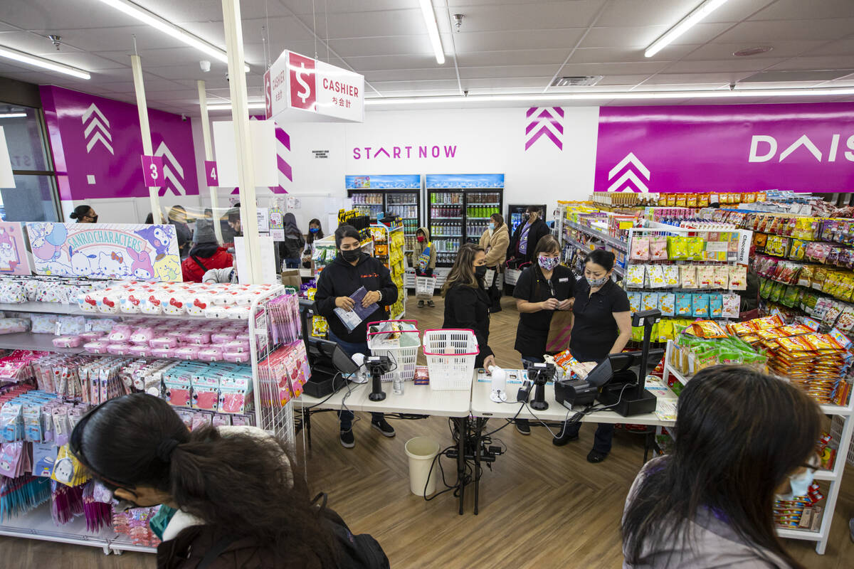 Customers check out during the grand opening of Daiso, a popular Japanese discount store, on We ...