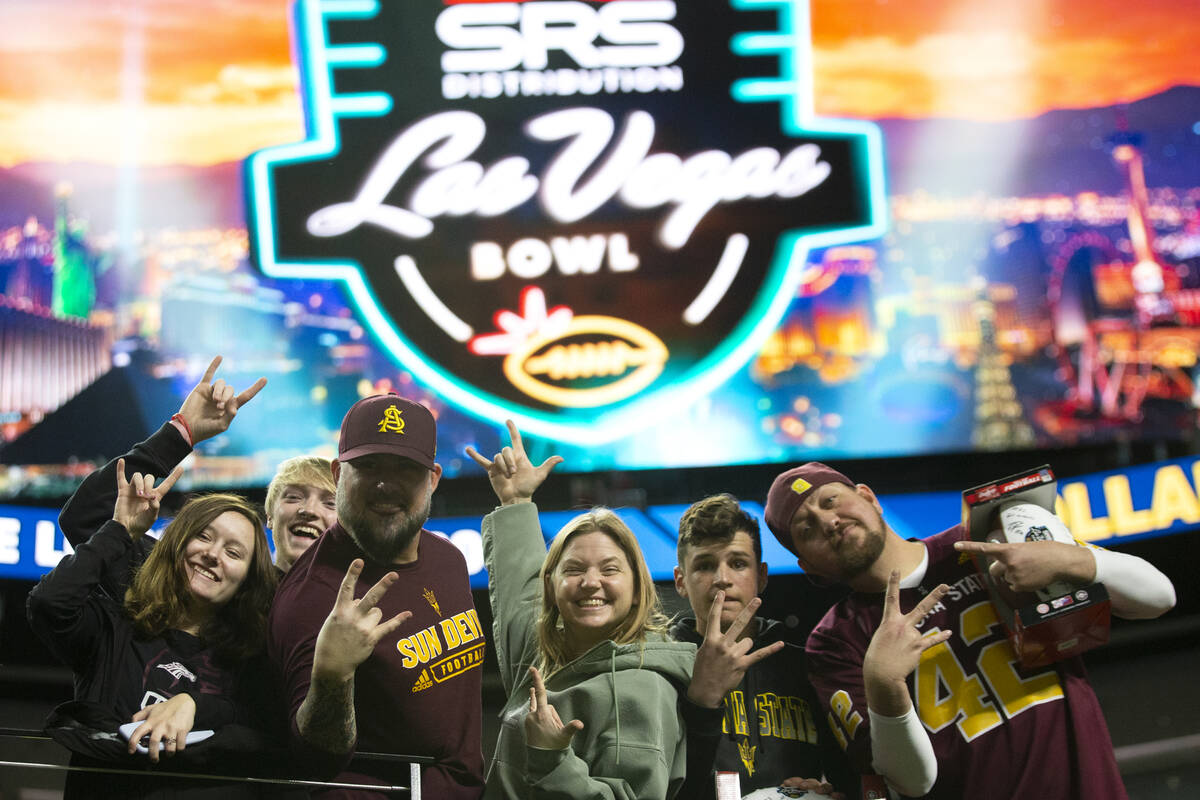 Arizona State Sun Devils fans pose for photos before the Las Vegas Bowl NCAA college football g ...