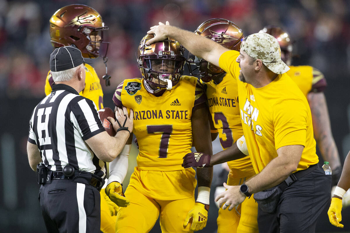 Arizona State Sun Devils coaching staff and teammates congratulate defensive back Timarcus Davi ...