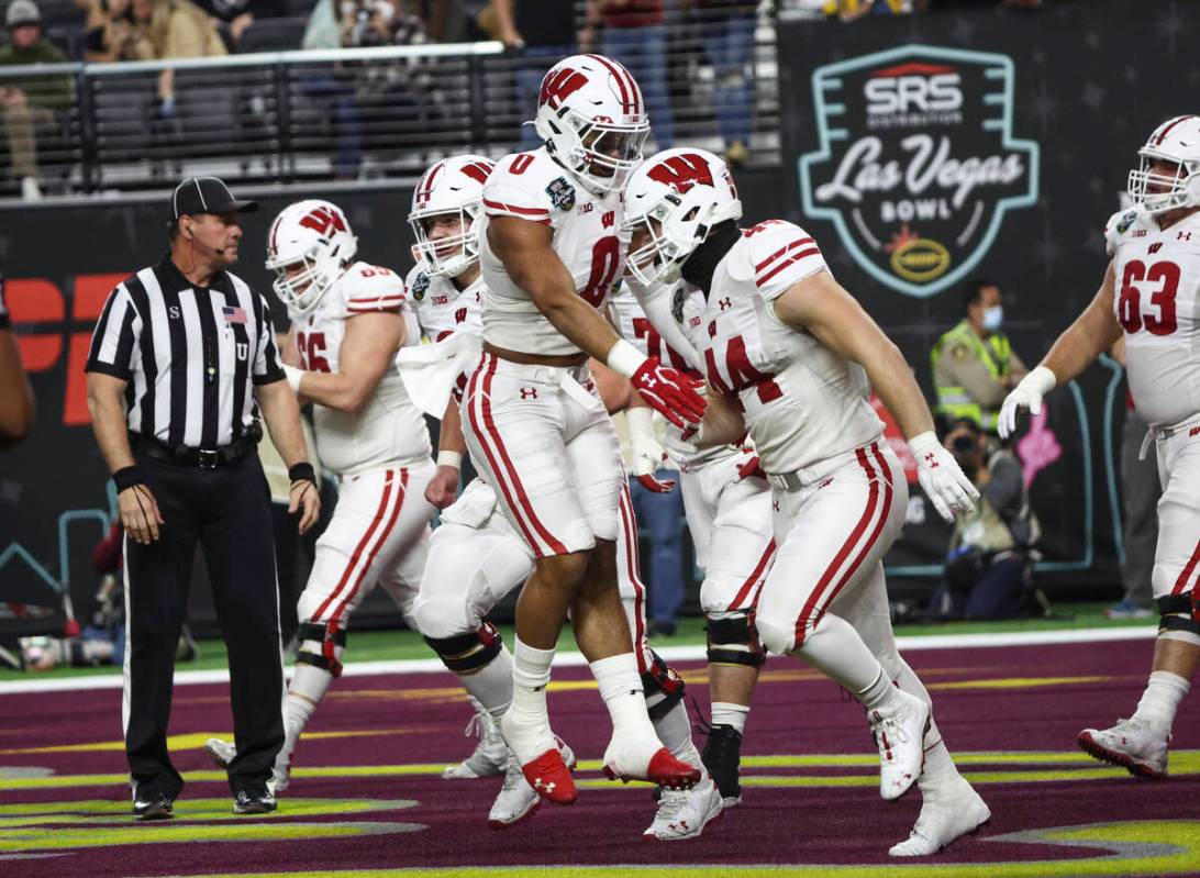 Wisconsin Badgers running back Braelon Allen (0) celebrates a touchdown by fullback John Chenal ...